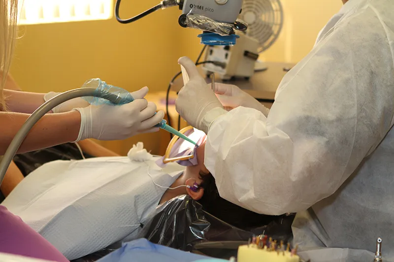 Endodontist performing a root canal treatment on a patient