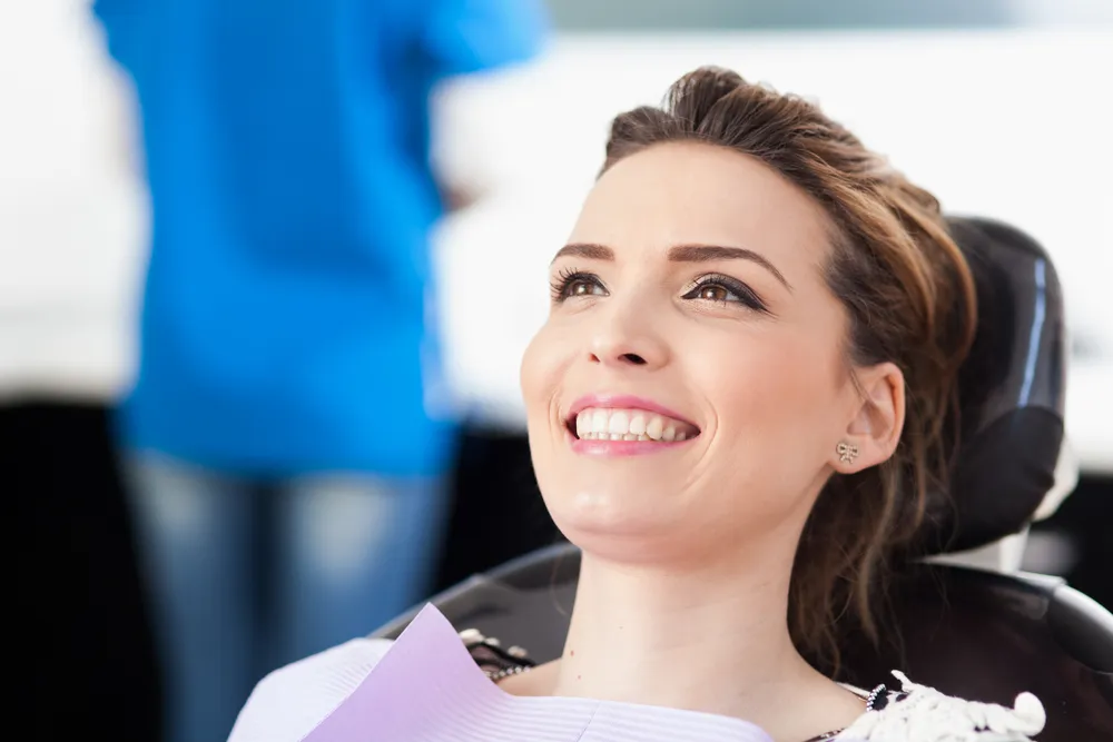 Woman smiling on a dental chair